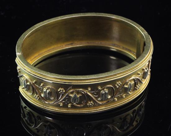 A Victorian gold hinged bracelet, in gilt tooled leather box.